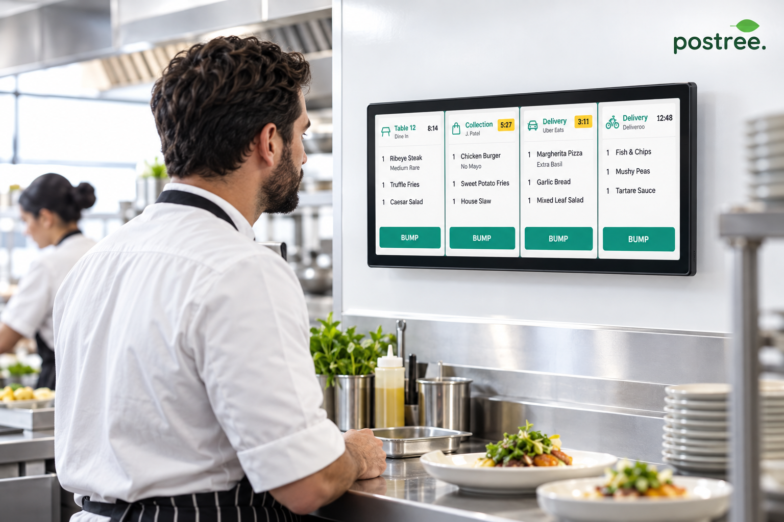 Chef reviewing a compact wall-mounted Postree kitchen order board.